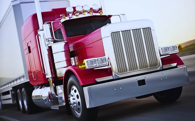 Generic semi truck hauling cargo down the road with motion blur.